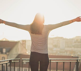 Person holding arms up to sun