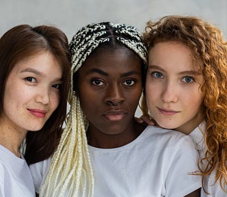 Diverse women standing close and looking at camera