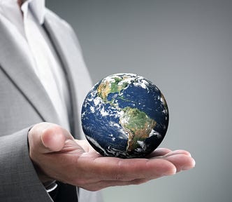Man in a suit holding a globe