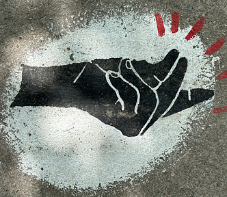 Sidewalk art of a snapping black hand in a white background