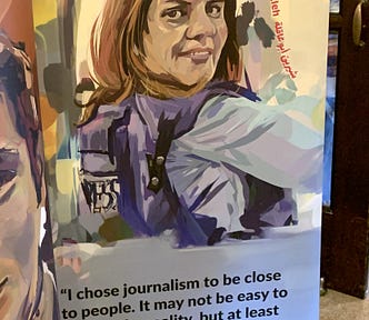 Shireen Abu Akleh, the Palestinian American al-Jazeera reporter whom Israel assassinated in May of 2021, a moment we can regard, in retrospect, as the first shot of the genocide (Photograph by the author; poster by artist Brice Patterson at the Palestine Writes Festival, Philadelphia, PA, Sep. 2023)