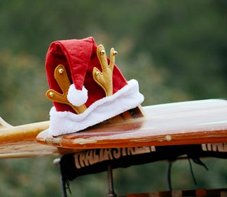 A Santa hat on a surf board illustrating the experience of Christmas in New Zealand.