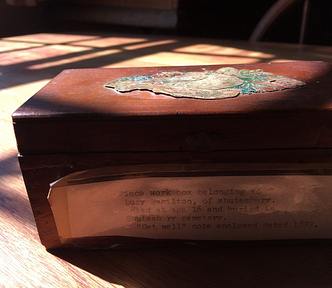 a photo of a sewing box in light and shadow