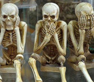 three skeletons in the hear no evil say no evil see no evil positions