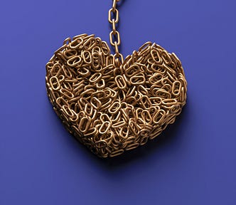 Photo of a heart made of golden chain, against a purple background.