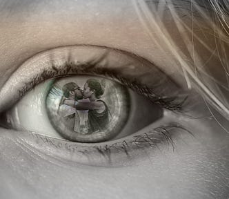 A woman’s eye and reflected on her pupil is the vision of the betrayal of her partner with another woman.