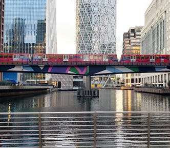 A train crosses a dock in Canary Wharf