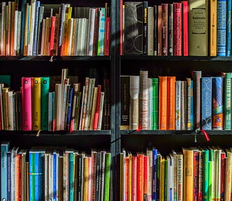 A photo of a library shelf full of books.