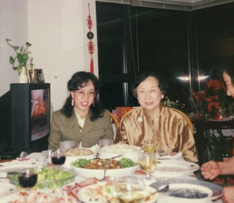 Two women seated at a dinner table.