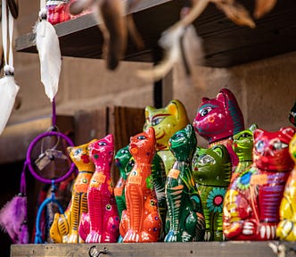A display of large, medium and small colorful cat dolls, by Sanath Kumar.