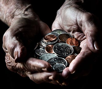 Old person’s cupped hands full of coins.