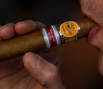 profile view of a person holding a Quay Dorsay cuban cigar in his mouth