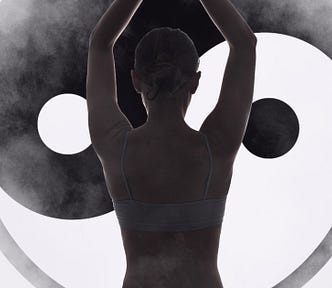 A woman doing yoga in front of a yin/yang symbol