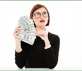 A photo of a young woman with a questioning look on her face holding a fan of hundred dollar bills.