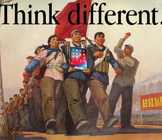 A Chinese revolutionary poster depicting a marching army of peasant soldiers. It has been altered so that a man at the front of the column is carrying an Ipad. The image is surmounted by Apple’s ‘Think Different’ wordmark.