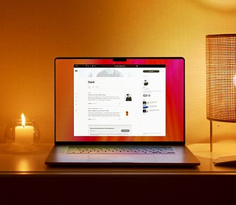 An image of a MacBook with Safari open alongside a lit candle