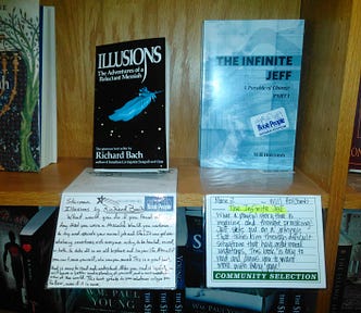 The Infinite Jeff, by author Will Holcomb on the shelf at Book People in Austin, Texas next to Richard Bach’s Illusions.