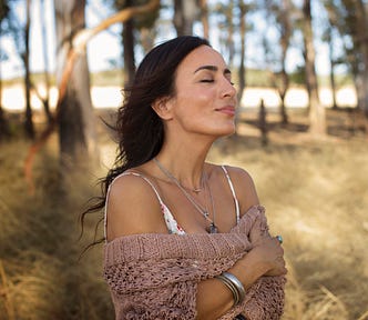 woman smiling hugging herself