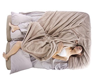 woman sleeping in tangled sheets