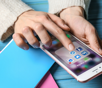 Hands tapping Twitter logo on cell phone — This Is Why People Happily Pay $5 for a Greeting Card but Won’t Pay $3 for Your Book