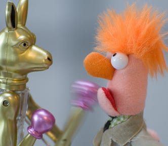 A kangaroo figurine is punching a doll figurine to show conflict.