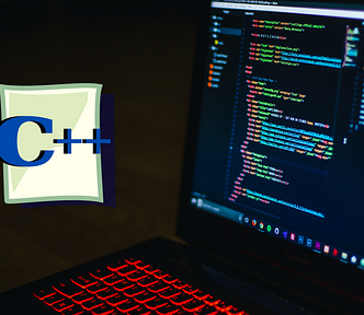 A laptop displays lines of codes with a c++ logo to its left.