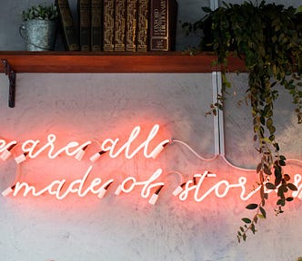 Neon sign says: We are all made of stories