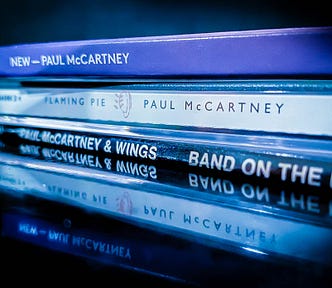 A stack of Paul McCartney albums from various decades