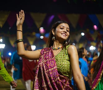 Young Indian woman dancing at a festival celebration.