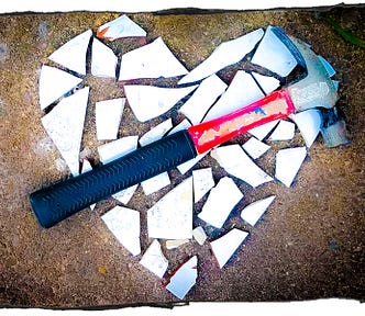 Picture of a hammer on the shards of a broken heart.