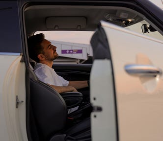 A guy dreaming in his car.