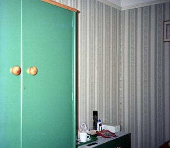 A bedroom in a bed and breakfast showing a wardrobe and a chest of drawers