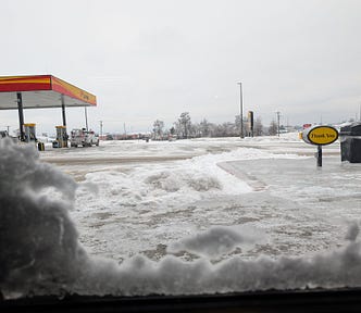 The view from a truck stop window on a snowy winter day.