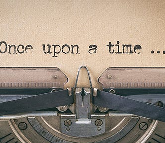 Close-up of a vintage typewriter typing “Once upon a time…” on textured paper. The scene conveys a nostalgic, storytelling atmosphere.