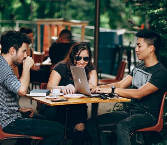 Three people discussing a business plan.