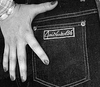 Black and white photo of the right back pocket of a pair of vintage Gloria Vanderbilt jeans. The models hand splayed out next to the pocket.