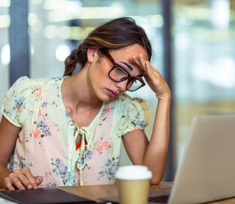 Frustrated female content creator looking at her laptop.