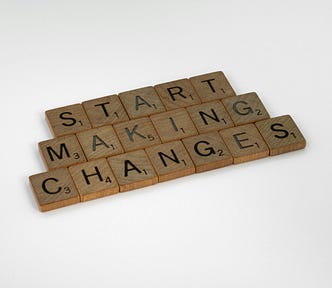 Scrabble tiles spell “Start Making Changes”.