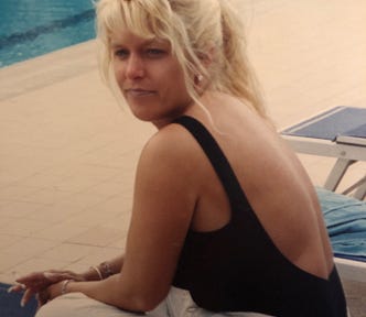 Lady sitting on chair by a pool