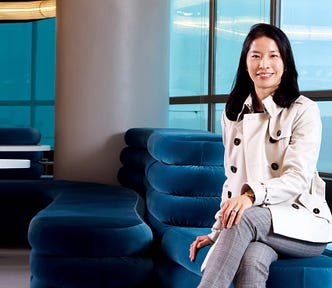 Dr Esther Chan Wai-yi smiling at the camera seated with her legs crossed at HKUMed’s learning commons