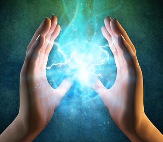 Two hands held in the air facing each other with lightning ball in the middle