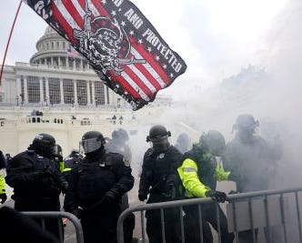 Image of Capitol Hill riots with police in the foreground