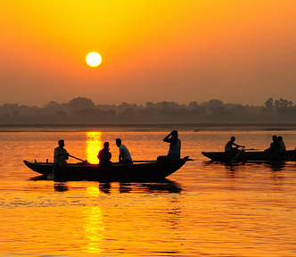 people in boats during sunset, golden sky, silhouettes