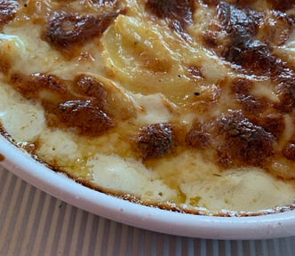 Gratin Dauphinois bubbling, brown, just out of the oven,