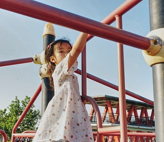 Child climbing on a jungle gym