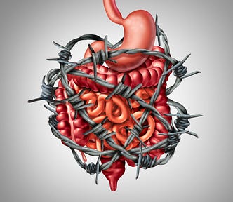 The stomach and intestines are surrounded by a barbed wire indicating painful digestion.