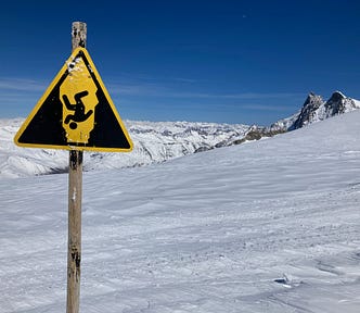 warning sign in snow-covered mountains