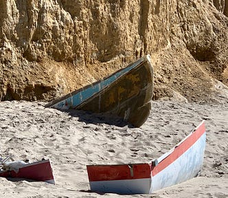 Parts of a boat on the beach. Photo by Mark Tulin.