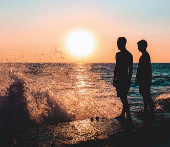 Two Men Standing on Seashore