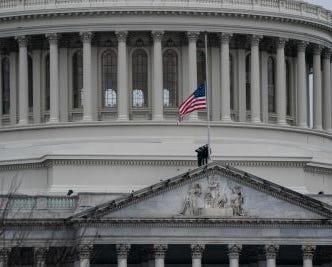 Image of the flag at half-mast in front of the Capitol building (NYT)